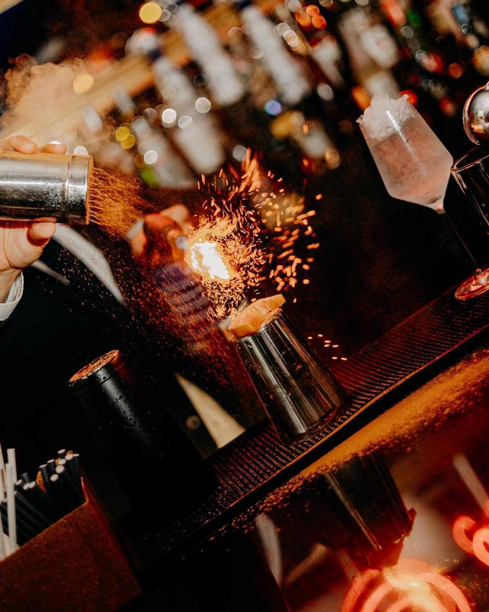 138 Liberdade Hotel Лиссабон Экстерьер фото A bartender using a cocktail gun to make a flaming shot